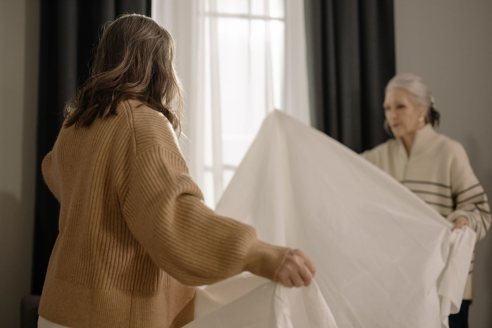 Companion caregiver helping a senior woman tidy the home in Cairo, GA