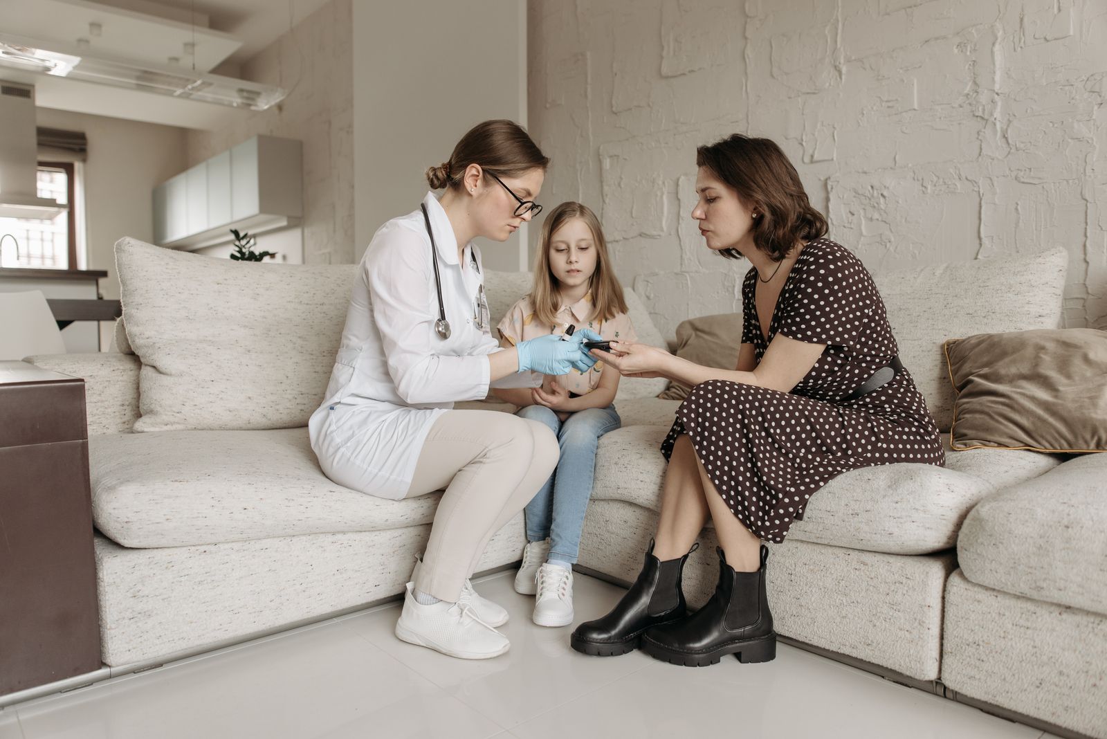 Pediatric caregiver supporting a child at home with a parent nearby in Atlanta, GA