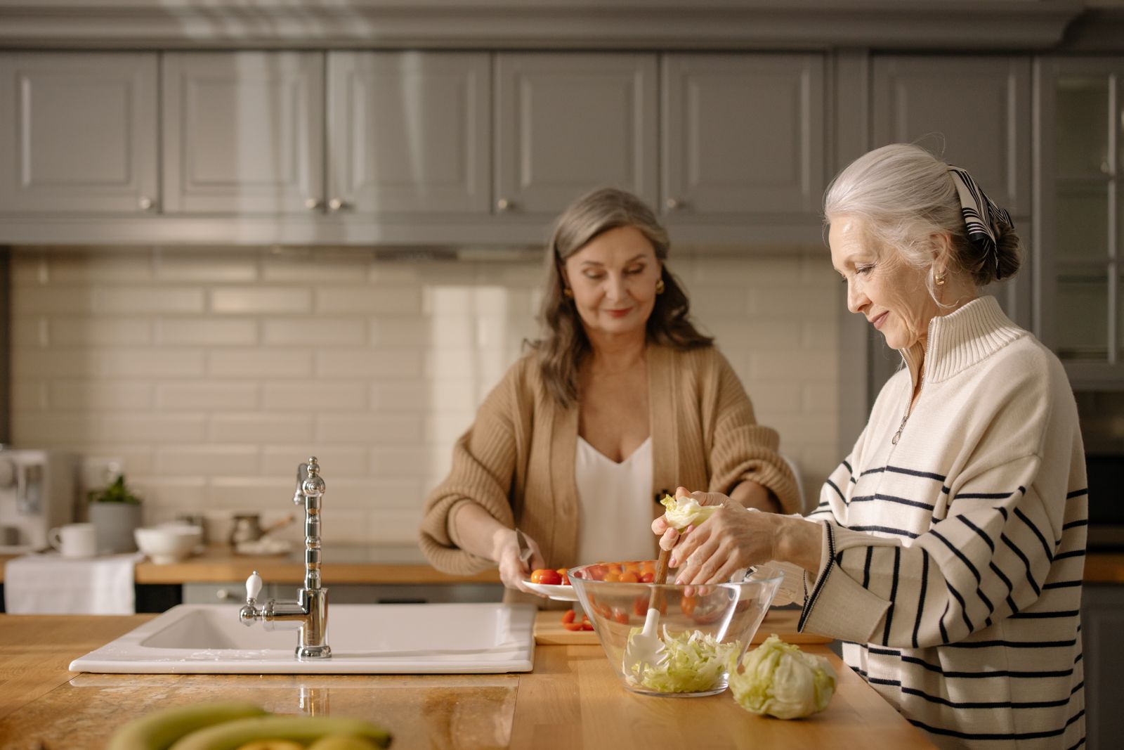 Caregiver and senior preparing a meal together at home in Cairo and Atlanta, GA